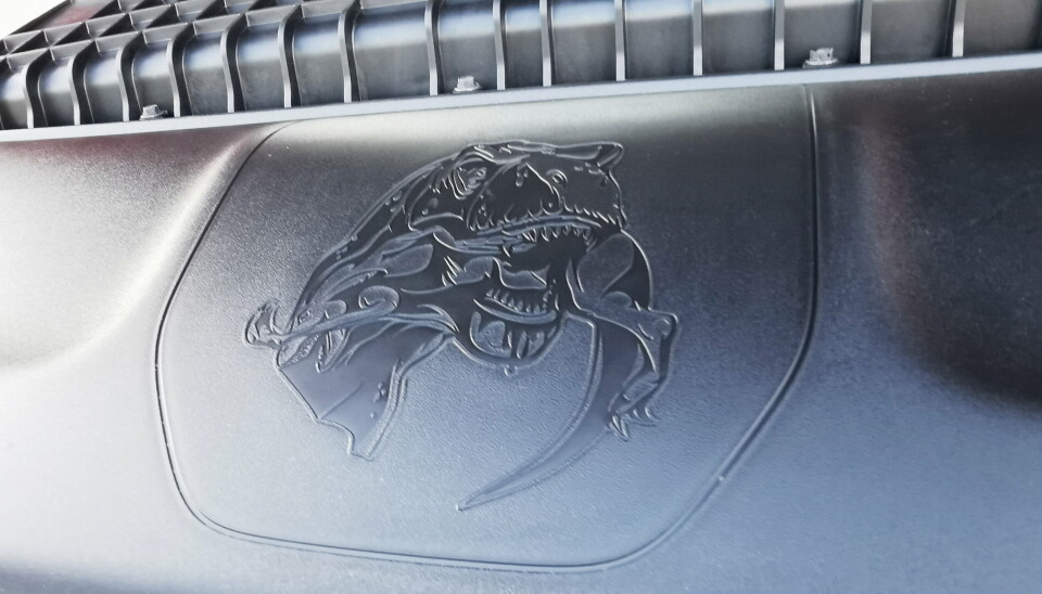 STIKK TIL FORD: Konkurransen i det amerikanske pickup-markedet er hard, og under panseret har RAM funnet det på sin plass med ett stikk til konkurrenten med et bilde av en Tyrannosaurus Rex som sluker et medlem i Raptor-familien.